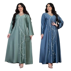 Detail view of satin abaya featuring intricate branch embroidery and shimmering sequins