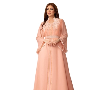 Detailed view of peach pink chiffon kaftan dress with luxury golden rhinestone embroidery
