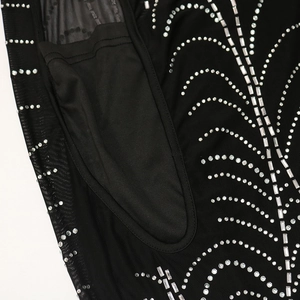 Detailed macro view of black sheer mesh fabric with sparkling silver rhinestone patterns