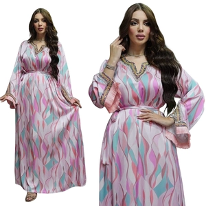 Detail of V-neck kaftan dress with colorful wave patterns and pink fringe sleeves