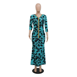 Detail of teal fishtail dress with black floral print and gold sequin V-neckline