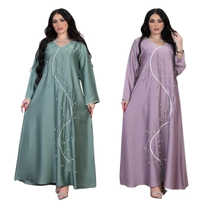 Detail of beaded leaf embroidery on V-neck long-sleeved satin abaya maxi dress