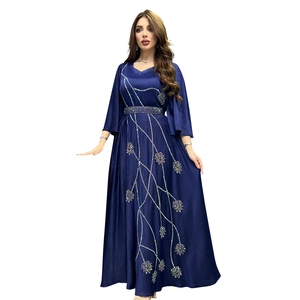 Detail of leaf rhinestone embroidery and sequin belt on navy blue kaftan dress
