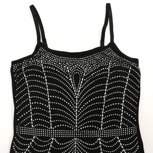 Detailed view of silver rhinestones in geometric patterns on black camisole top