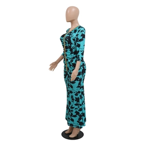 Side view of kaftan mermaid dress featuring blue floral print and gold woven trim detail