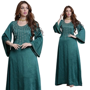 Detail of V-neck embroidery and bell sleeves on a dark green pleated abaya dress