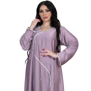 Detailed close-up of silver rhinestone leaf patterns on light purple silk abaya dress