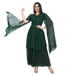 Detail of dark green sequin evening dress featuring flowing wide sleeves and chiffon skirt