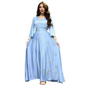 Close-up of sparkling sequin leaf embroidery on luxury light blue satin evening gown