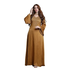 Macro detail of V-neck embroidery and sequins on bronze flare sleeve Abaya maxi dress