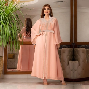Detail view of pink chiffon kaftan dress with sparkling rhinestones and flared sleeves