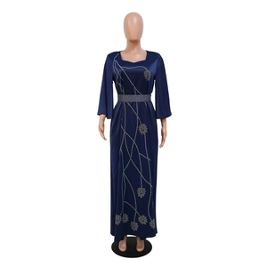 Detail of navy velvet kaftan dress with silver leaf sequins and waist belt decoration