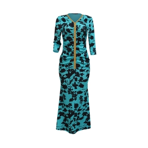 Detail of blue kaftan dress showing V-neckline with gold trim and black floral prints