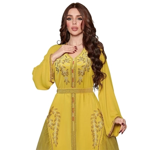 Detailed view of yellow Kaftan dress with golden sequin embroidery and sheer mesh layers