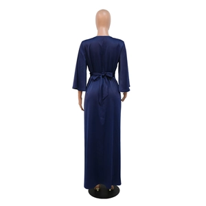 Detailed back view of a navy blue satin gown featuring an elegant waist tie and floor length