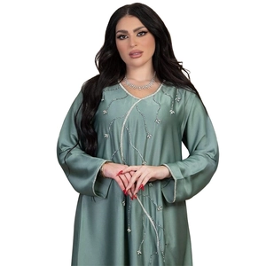 Detailed view of sage green abaya featuring silver leaf embroidery and satin finish