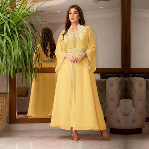 Close-up of silver bead embroidery and sequins on mustard yellow kaftan chiffon dress