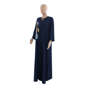 Detail of sequin embroidery and lace-up V-neck on a loose dark blue maxi dress