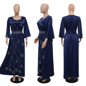 Three-view shot of a navy blue satin gown featuring leaf patterns and flared sleeves