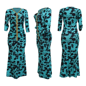 Detailed views of a slim-fit teal fishtail dress with black floral prints and gold sequins