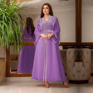 Detail of purple chiffon kaftan with gold sequins, beading, and elegant flared sleeves