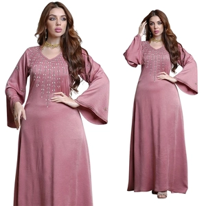 Detailed view of silver bead embroidery on the V-neck and flare sleeves of this pink kaftan