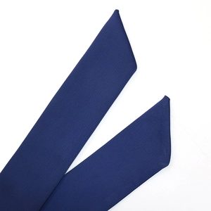 Detailed macro view of dark blue satin fabric with leaf pattern and fine twill texture