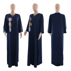 Detailed view of sequin embroidery and navy blue kaftan dress with V-neck ties