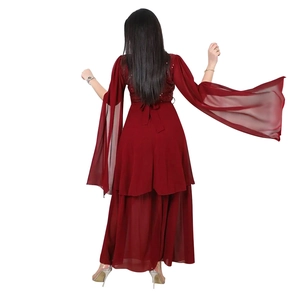 Detail of burgundy sequined evening dress featuring layered skirt and flowing long sleeves