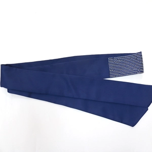 Macro shot of dark blue silk belt featuring a rectangle pattern of white rhinestones
