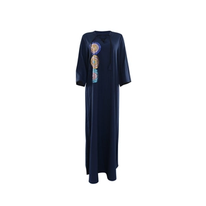 Detail of navy blue V-neck dress showing colorful sequin embroidery and tie-up neckline