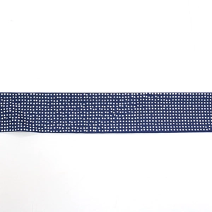 Detailed view of leaf pattern rhinestone belt trim with silver crystals on navy fabric