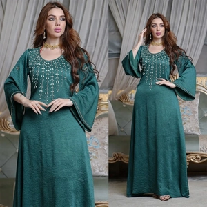 Detail of flared sleeves and golden bead embroidery on green V-neck Abaya kaftan dress