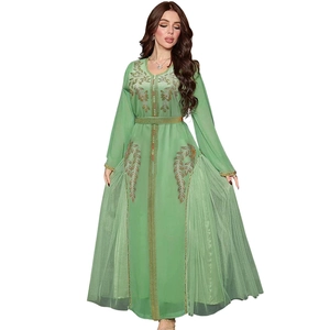 Detailed embroidery and gold sequins on a mint green mesh kaftan evening dress