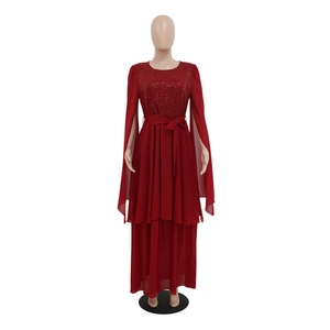 Detailed view of red sequin evening dress with split long sleeves and bow belt detail