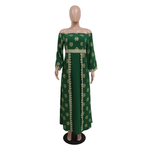 Detailed view of dark green ethnic dress with gold floral patterns and lace embroidery