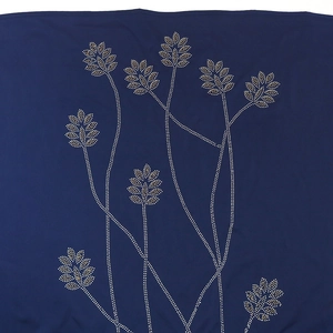 Detailed close-up of leaf rhinestone patterns on navy blue long robe dress fabric