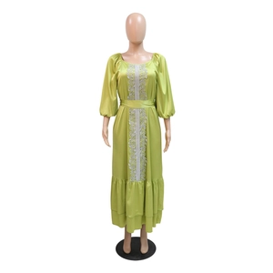 Close-up of lime green kaftan dress with silver lace applique and puff sleeves detail