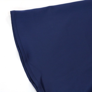 Detail shot of navy blue gown sleeve with precise stitching and leaf-patterned fabric texture