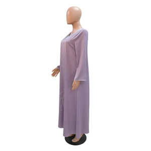 Detailed side view of a purple rhinestone abaya dress with flowing fabric and long sleeves