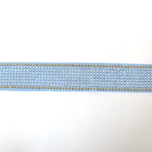 Detailed view of light blue kaftan belt with sparkling gold and white rhinestones