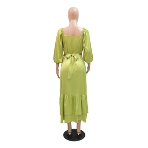 Rear view of a lime green satin kaftan dress featuring puff sleeves and a waist bow tie