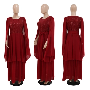 Detail of red sequin evening dress with cape sleeves and double-layered chiffon skirt