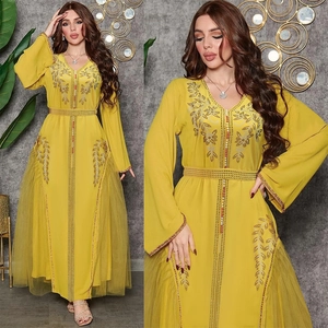 Close-up of yellow Abaya featuring intricate gold beadwork, sequins and sheer mesh panels