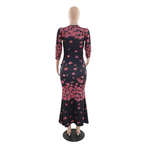 Rear view of slim fit black fishtail dress with pink floral print and long sleeves