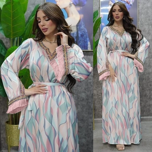 Detail of V-neck beaded embroidery and tassel cuffs on this printed kaftan maxi dress
