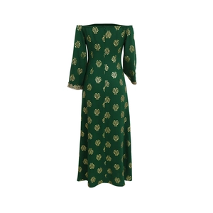 Detail of deep green ethnic dress featuring gold floral stamping and lace sleeve cuffs