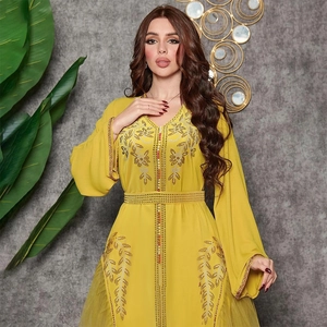 Close-up of golden beaded floral embroidery on yellow kaftan dress with mesh sleeves