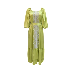Detail of lime green satin kaftan dress showing silver embroidery and lantern sleeves
