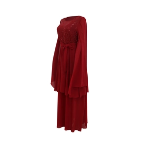 Detail of sequined bodice and flared sleeves on a dark red evening dress with belt